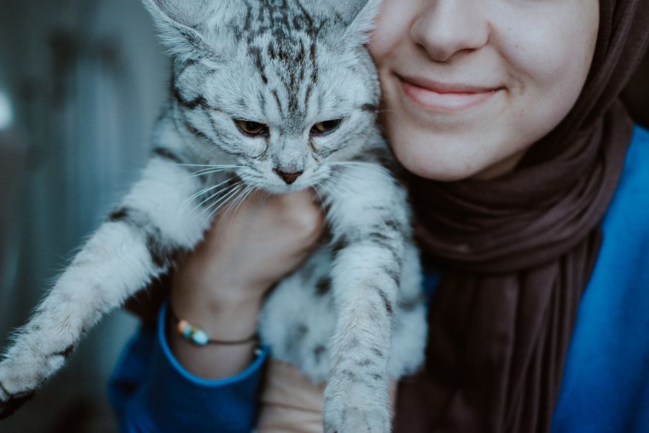 部屋で猫を抱く女性