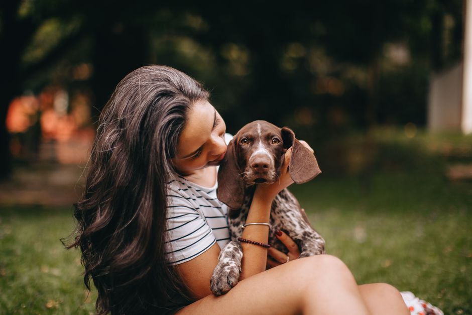 屋外で犬を抱きしめる女性